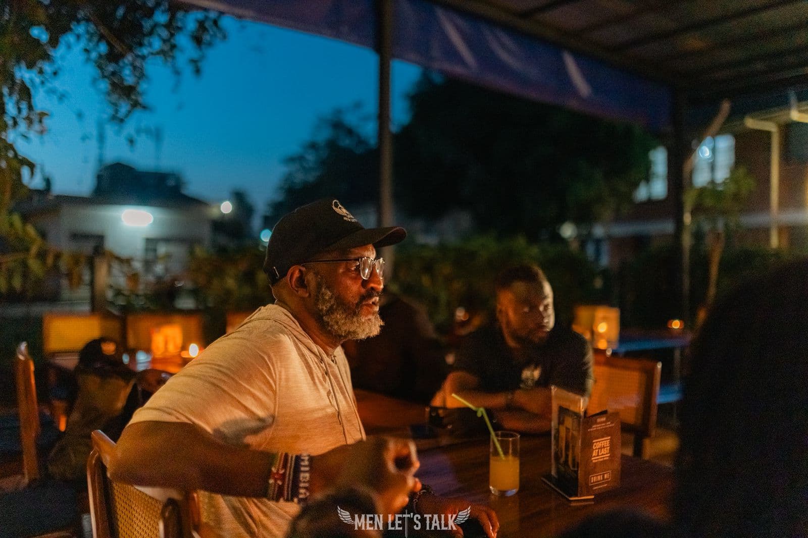 A small group of Men Let's Talk members gathered around a table at an evening event