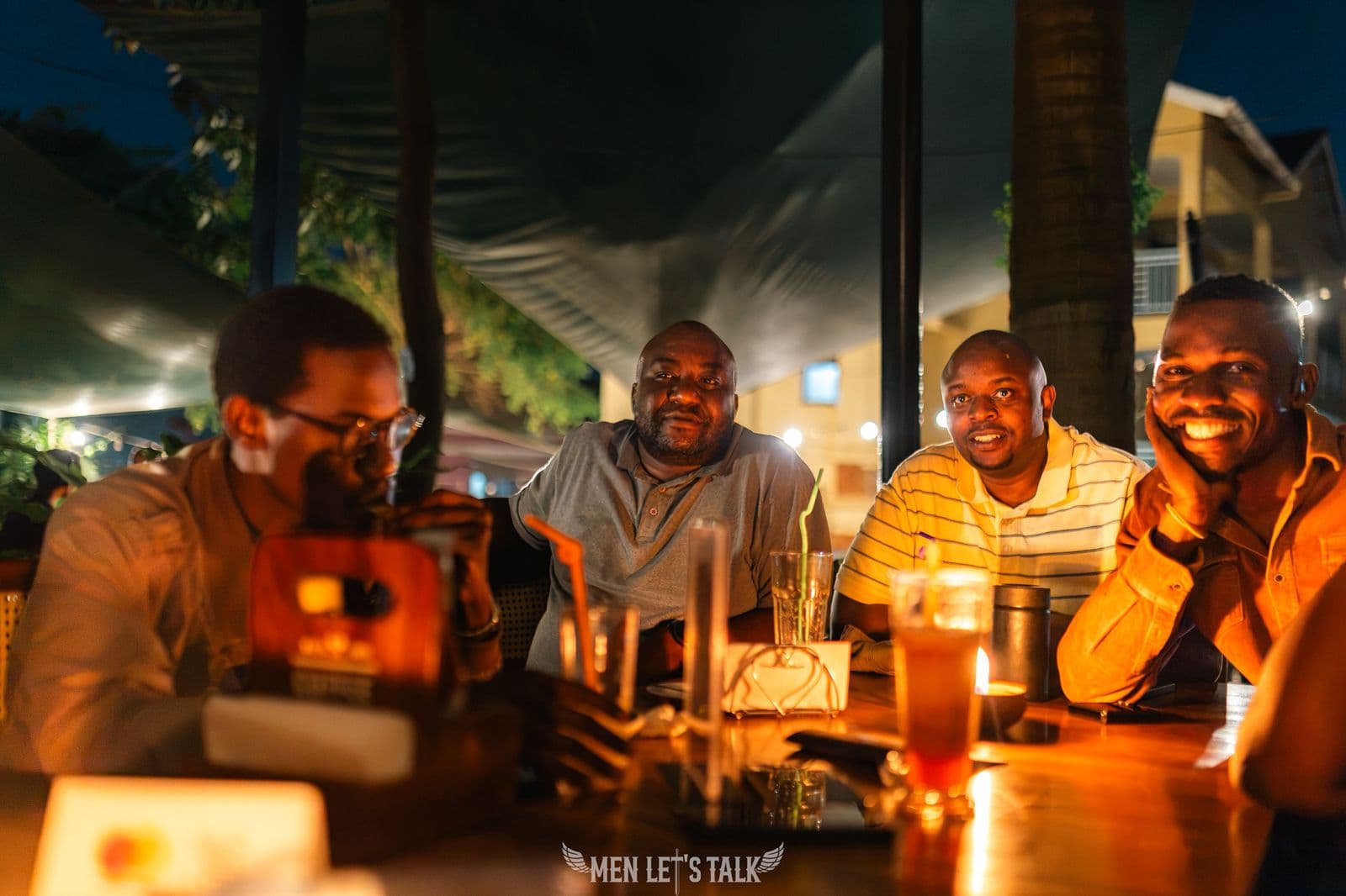 A group of Men Let's Talk members laughing together at a table